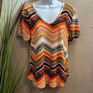#93 Forbidden Society, fiesta printed short sleeve top size large